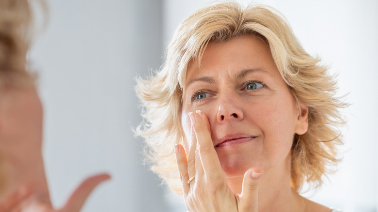 Woman applying a face cream.