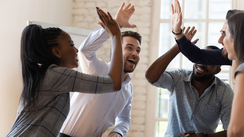 office workers high-fiving