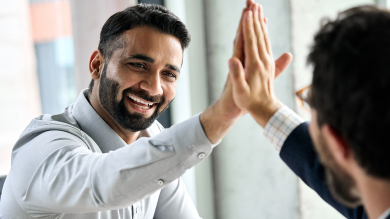 two men high-fiving