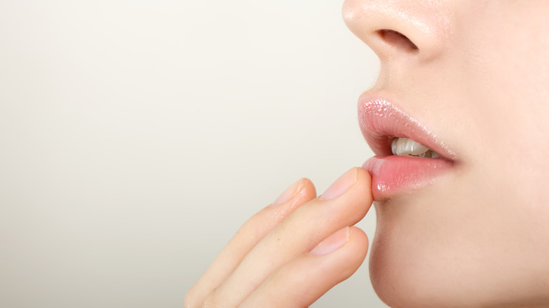 Woman applying lip balm