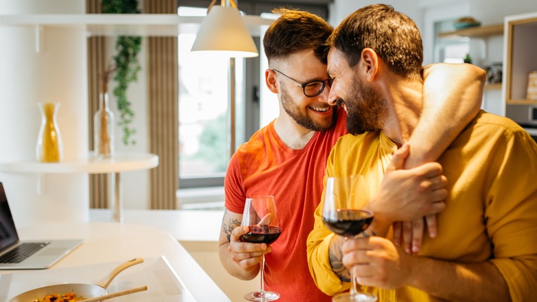 couple hugging and drinking wine