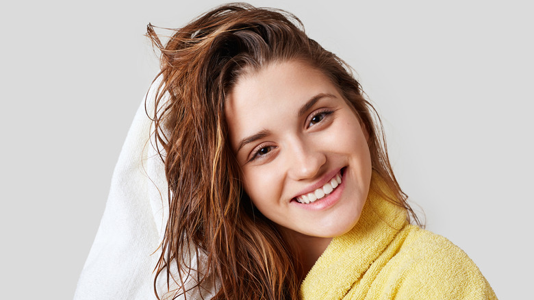 women drying wet hair with towel