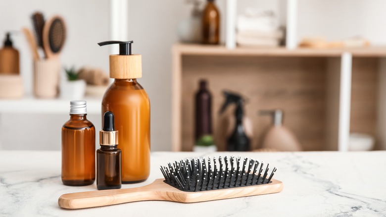 hair products and brush on counter