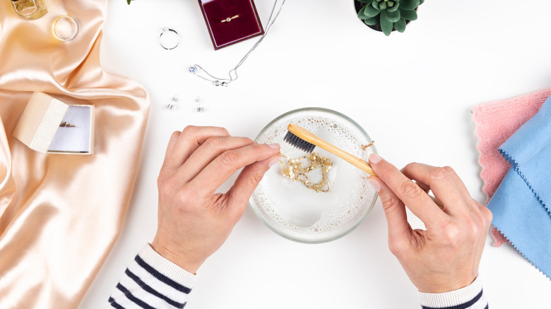 washing jewelry with brush