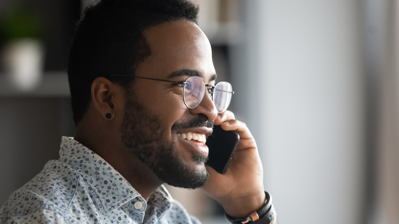 Smiling Black man on phone