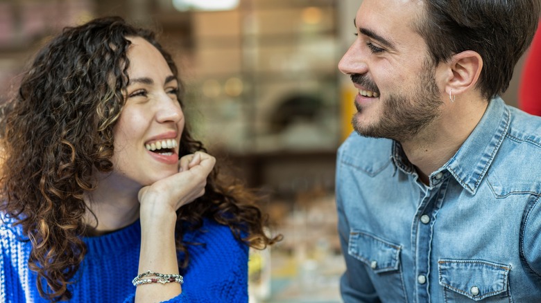 A happy couple smiling at each other