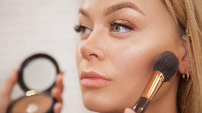 woman getting makeup applied