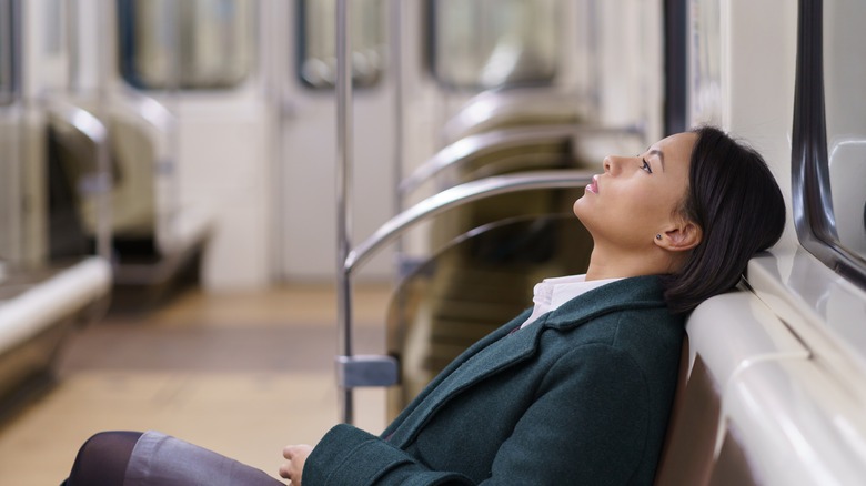 Woman resting on subway
