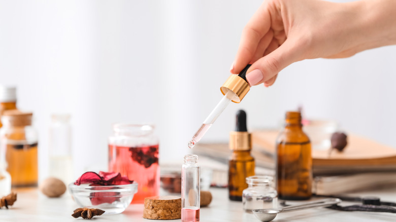 Woman mixing perfume scents