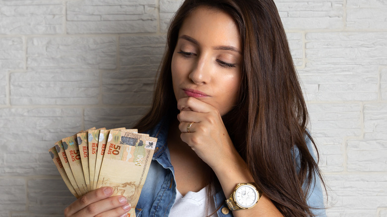 Female holding cash 