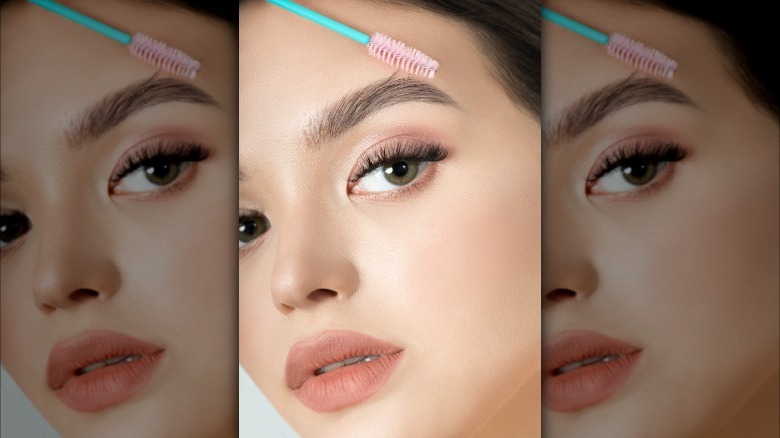 Woman brushing her eyebrows