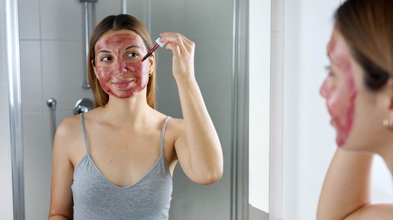 Woman using an exfoliating face mask