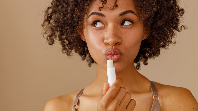Woman posing with lip balm
