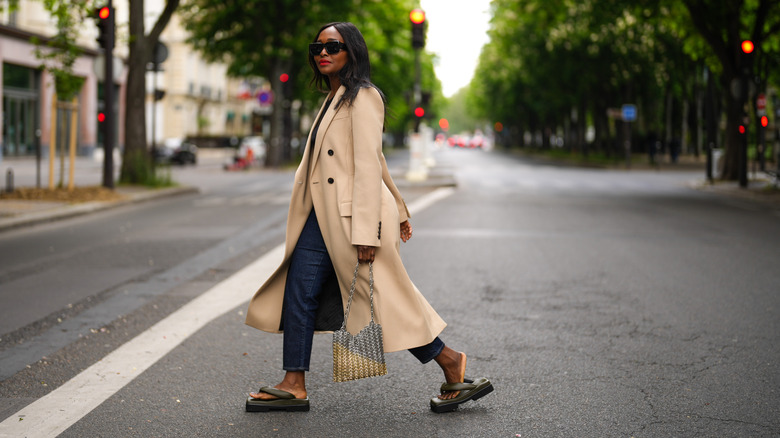 Woman wearing boyfriend jeans and maxi coat