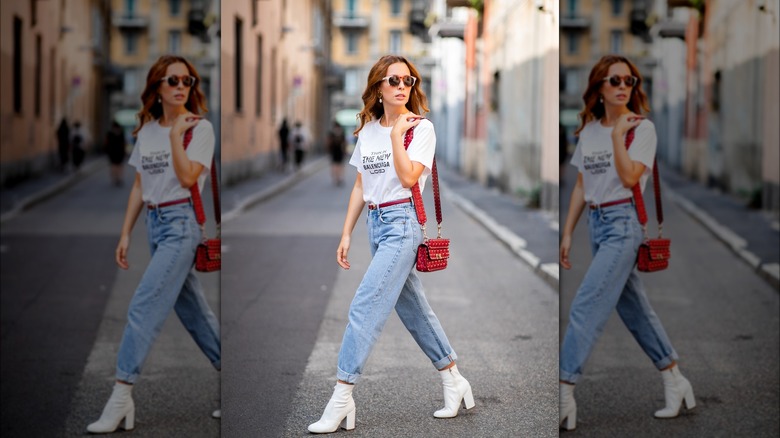 Woman wearing boyfriend jeans and white boots