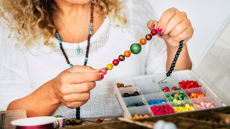 Woman making a colorful bracelet
