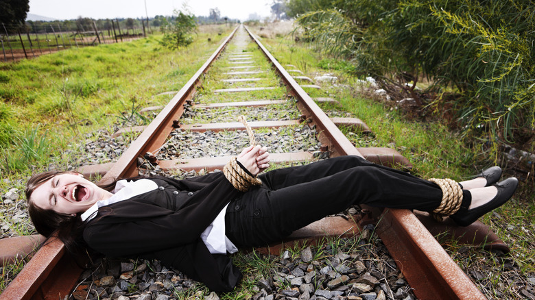 person on railroad tracks