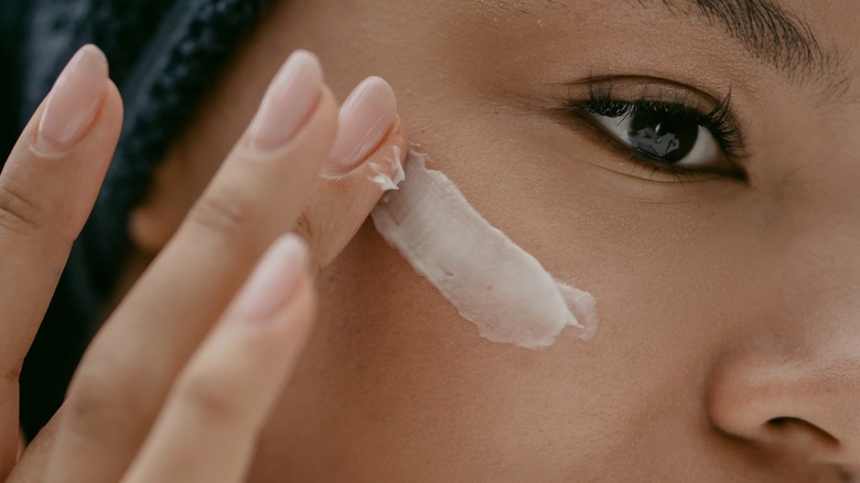 female applying cream 