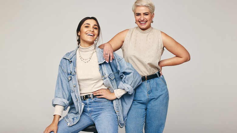 Two women wearing jeans