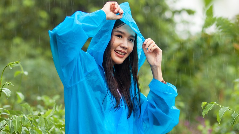 female in blue raincoat