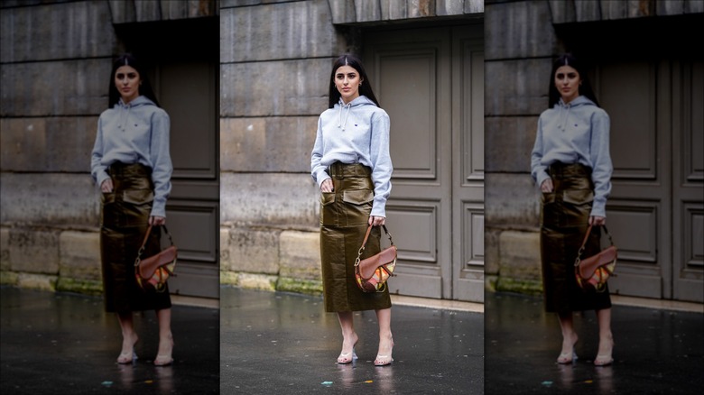 woman wearing sweatshirt and leather skirt