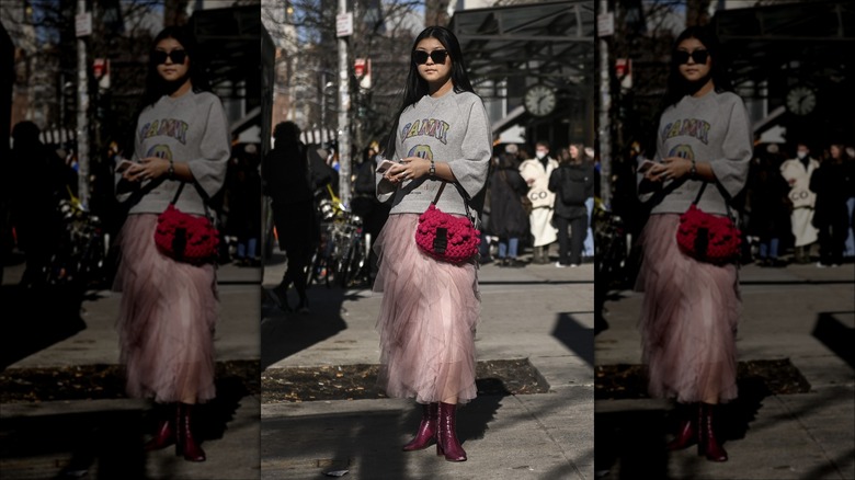 woman wearing sweatshirt and skirt