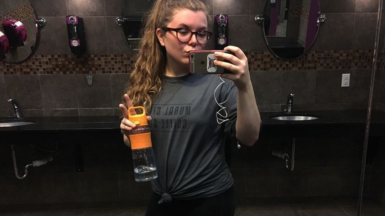 woman taking selfie in bathroom