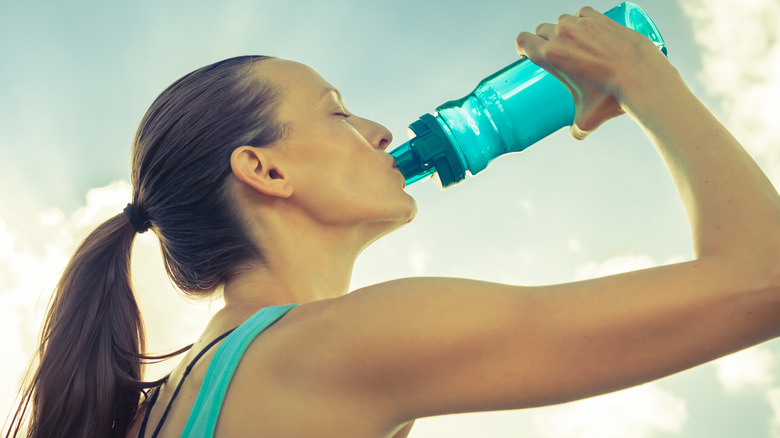 woman drinking sports drink