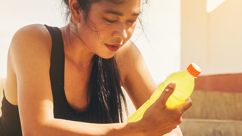 woman holding drink post workout