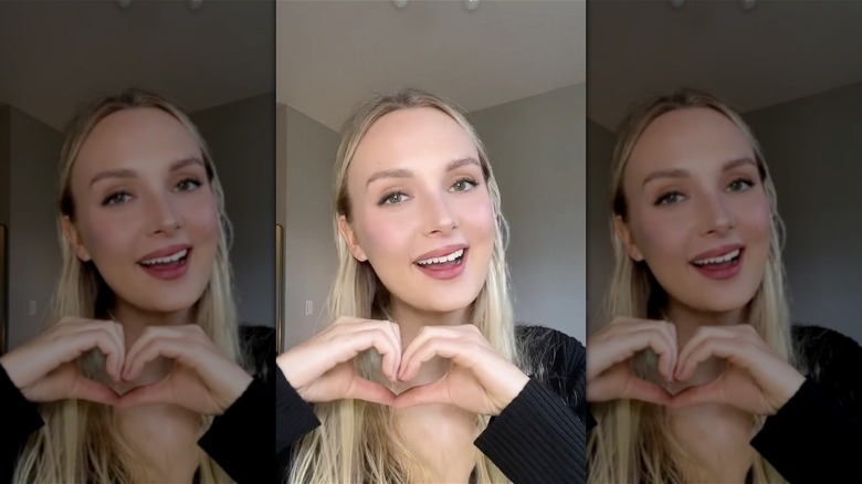 woman making heart sign