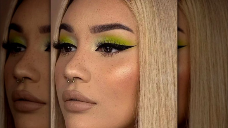 A girl with green eyeshadow and black eyeliner