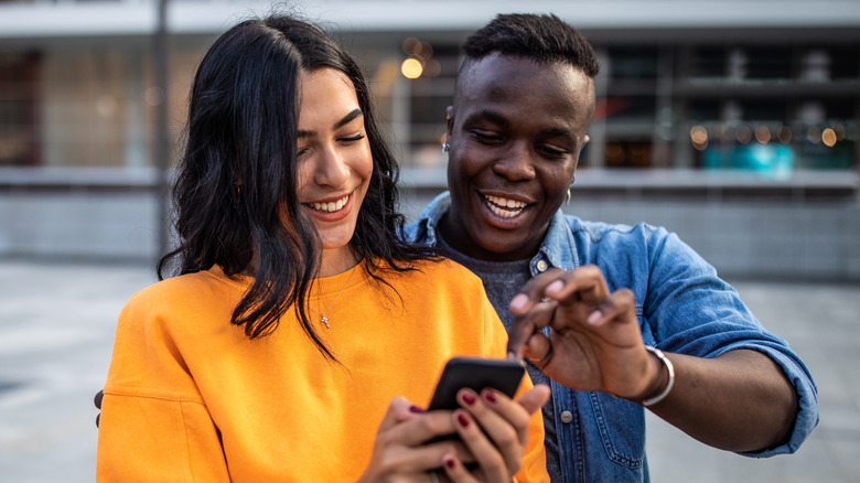 Man and woman looking at phone together