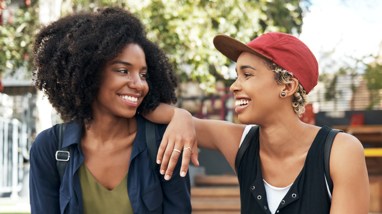 Two women smiling and talking