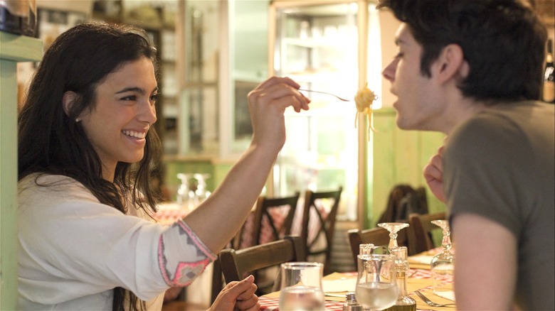 Woman offering man bite of food