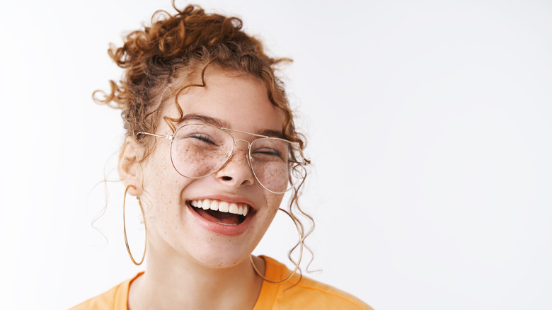 woman with messy bun smiling