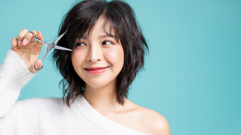 woman cutting her bangs