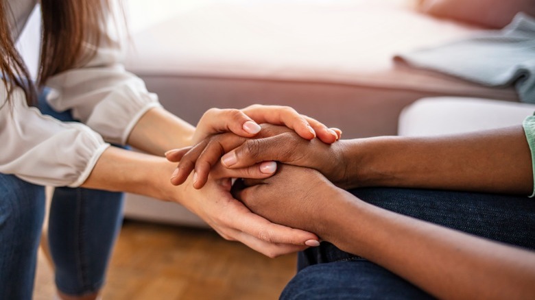 Two people holding hands