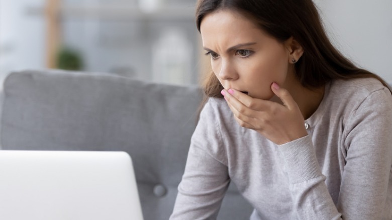 Concerned woman looking at computer