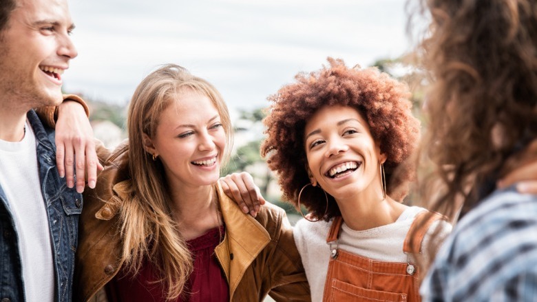 Friends smiling and hugging