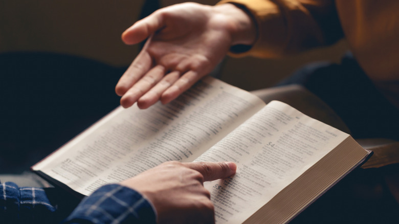 hands with religious book