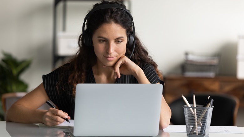 Woman researches on laptop