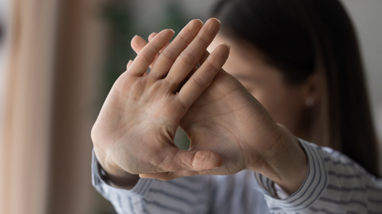 Woman holding up hands