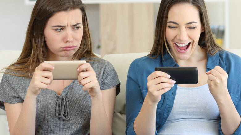 Two women on their phones