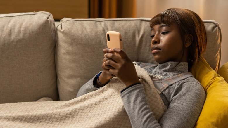  woman on couch with phone