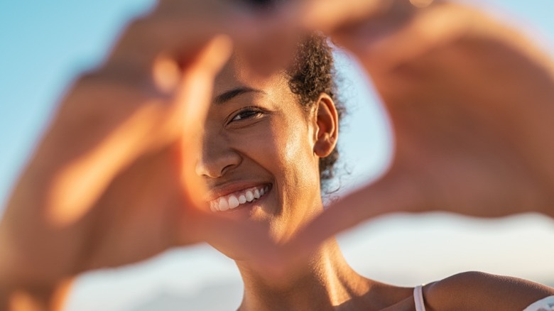 Woman making heart shape