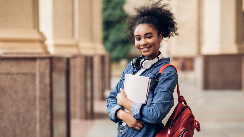 young black girl smiling with school books