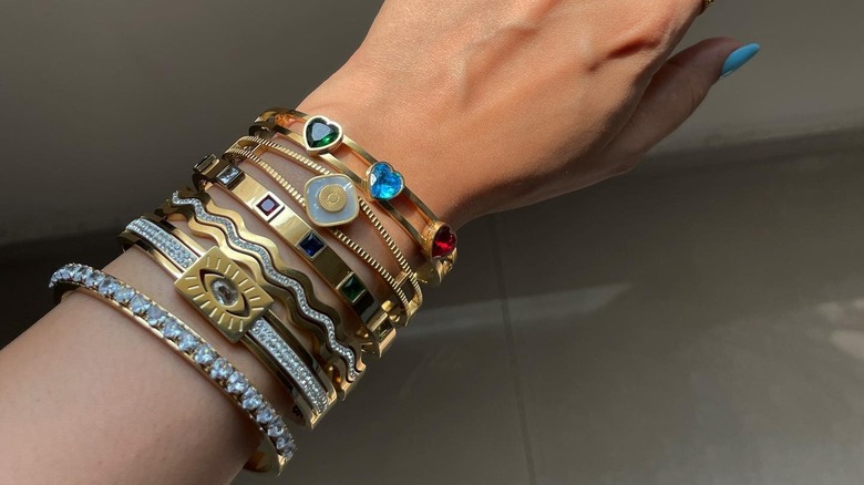 Wrist with stacked diamond, gemstone bracelets