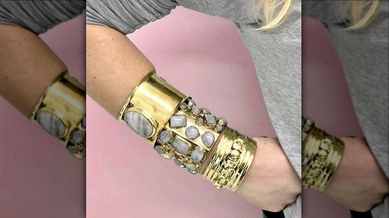 Arm with stacked gold cuffs