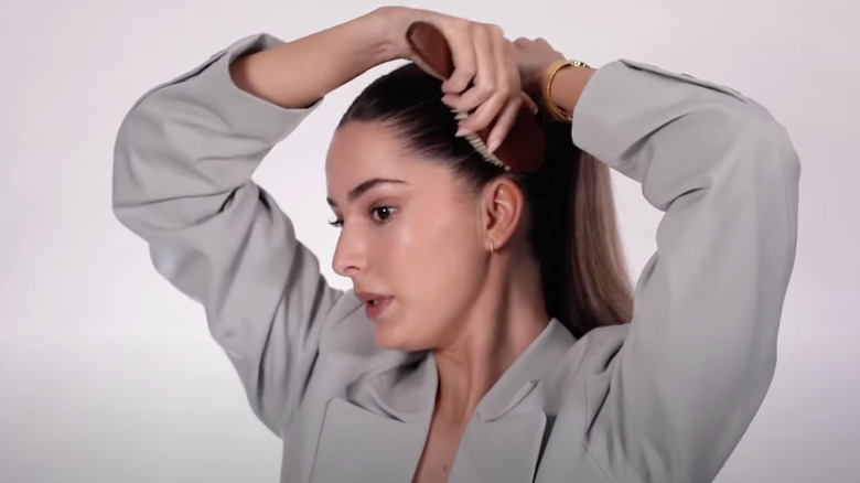 A woman tying her hair up