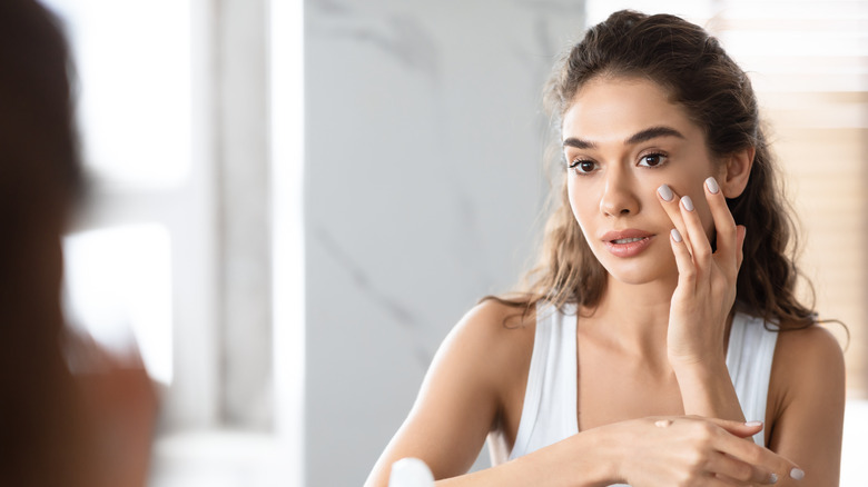 Woman applying foundation with fingers